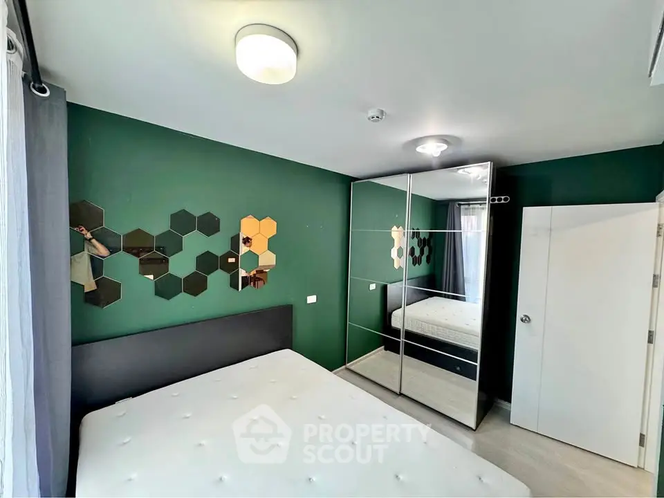 Modern bedroom with stylish decor and mirrored wardrobe