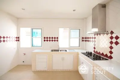 Modern kitchen with gas stove and sleek white cabinetry