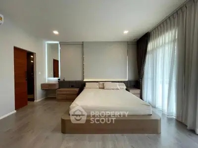 Spacious modern bedroom with large windows and elegant decor