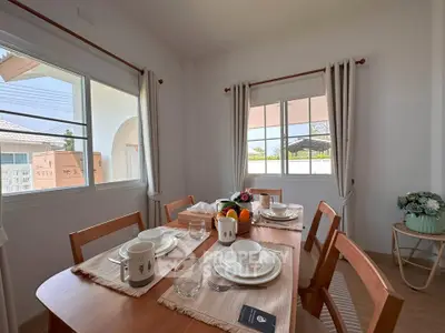 Charming dining area with natural light and elegant table setting in a cozy home.