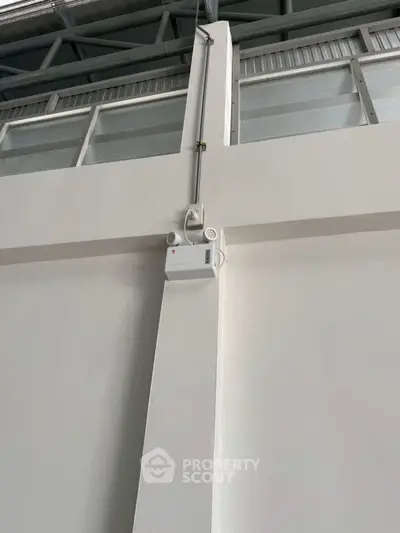 Modern industrial interior with high ceiling and electrical installations