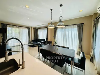 Spacious modern living room with elegant dining area and large windows