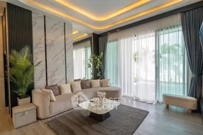 Luxurious living room with modern decor, large windows, and elegant lighting.