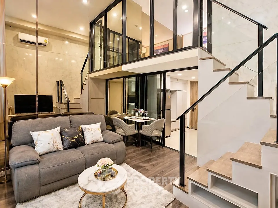 Luxurious modern living room with mezzanine, elegant decor, and stylish furniture in a contemporary apartment.