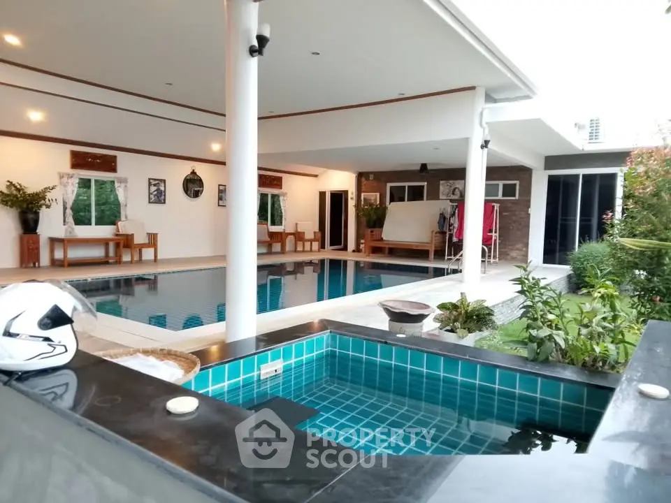 Luxurious villa with private pool and modern outdoor living space, perfect for relaxation and entertainment.