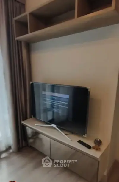 Modern living room with sleek TV setup and stylish shelving