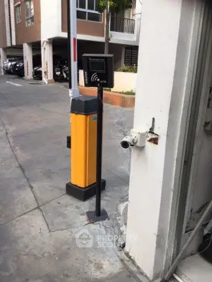 Secure parking entrance with access control system in modern building complex.