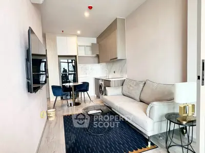 Modern living room with sleek kitchen and cozy seating area