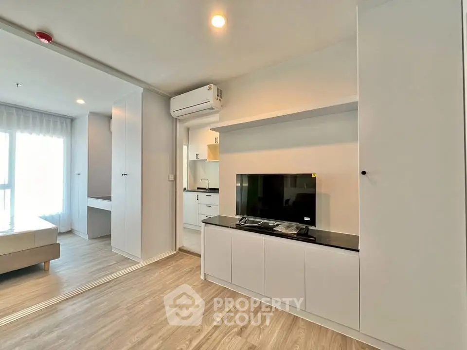 Modern living room with sleek design and natural light in a contemporary apartment.