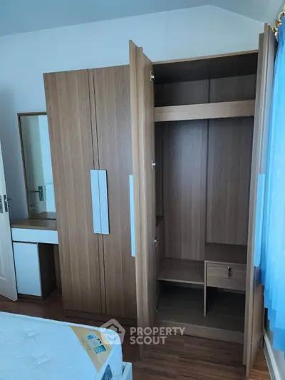 Spacious bedroom with modern wooden wardrobe and cozy decor