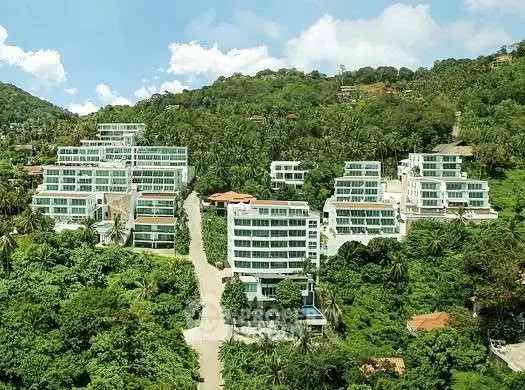 Luxurious hillside residential complex with stunning panoramic views and lush greenery.