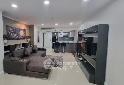 Modern open-plan living room with sleek kitchen and stylish decor