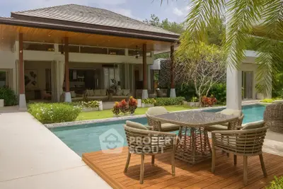Luxurious villa with poolside deck and lush garden, perfect for outdoor relaxation and entertainment.