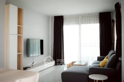 Modern living room with sleek furniture and large window for natural light.