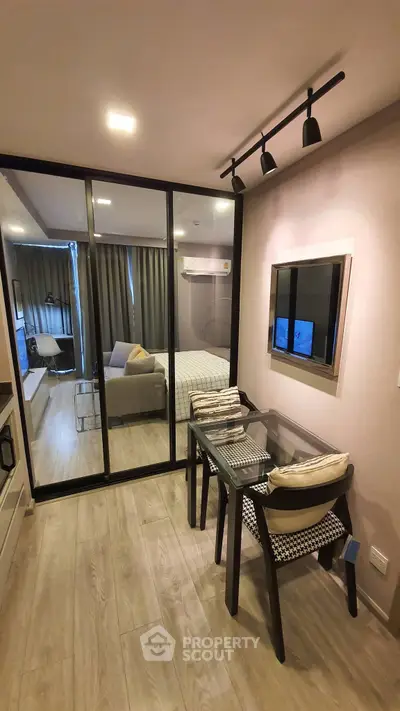 Modern compact living room with glass partition and stylish furniture