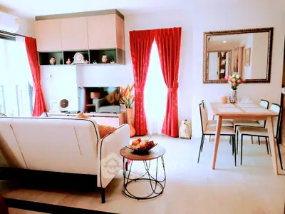 Stylish living room with red curtains and modern dining area in open layout apartment.