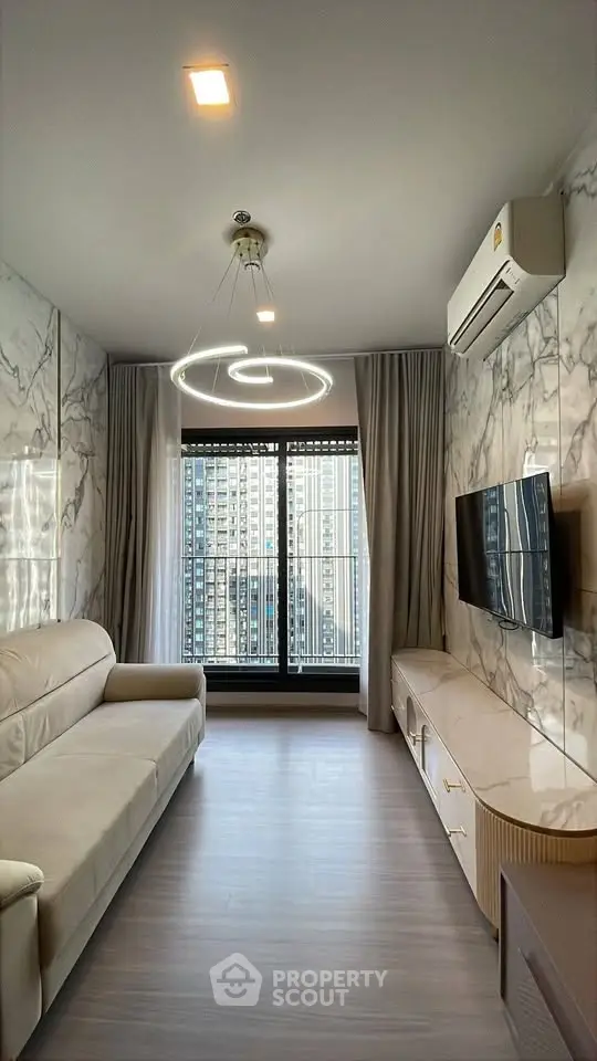 Modern living room with marble walls, sleek furniture, and city view from large window.