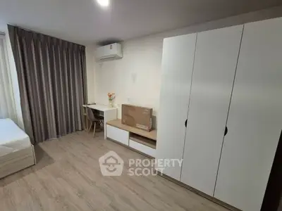 Modern bedroom with sleek furniture and ample storage space