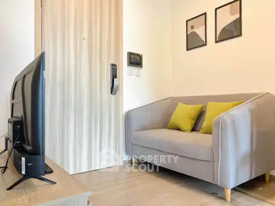 Cozy living room with modern sofa and TV, perfect for relaxation.