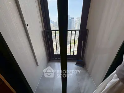 Compact balcony with city view in modern high-rise apartment