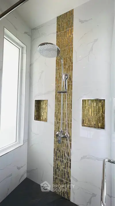 Modern bathroom shower with elegant tile design and built-in shelves