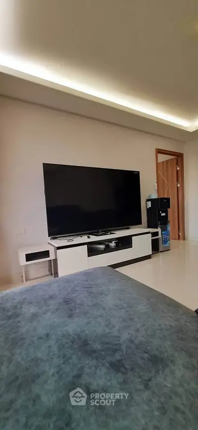 Spacious living room with modern entertainment setup and sleek furniture design.