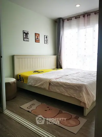 Cozy bedroom with natural light, stylish decor, and comfortable bedding in modern apartment.