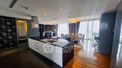 Luxurious open-plan kitchen and dining area with modern design and panoramic city views.