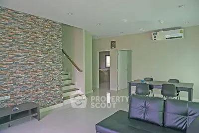 Modern living room with stylish stone accent wall and sleek furniture
