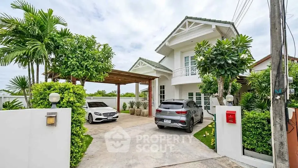 Charming suburban house with lush garden and carport, featuring modern architecture and inviting driveway.