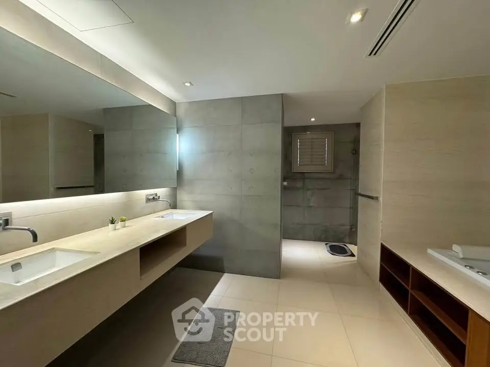 Spacious modern bathroom with dual sinks and elegant lighting