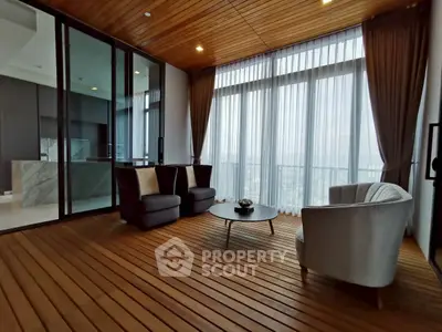 Luxurious living room with floor-to-ceiling windows and elegant wooden flooring.