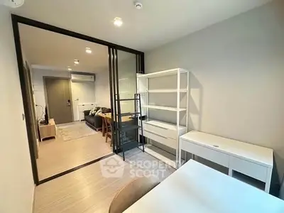 Modern apartment interior with open layout, featuring a stylish living room and study area.