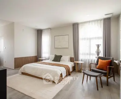 Spacious modern bedroom with elegant decor and natural light