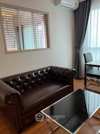 Stylish living room with leather sofa and modern decor in a cozy apartment.