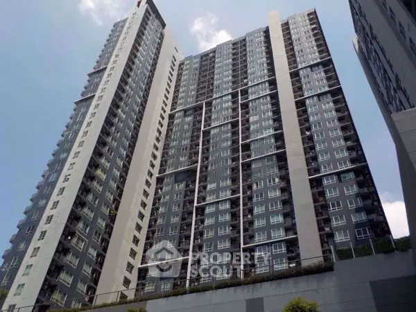 Modern high-rise residential building with sleek design and numerous windows, perfect for urban living.