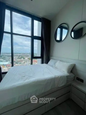 Modern bedroom with stunning city view and large windows