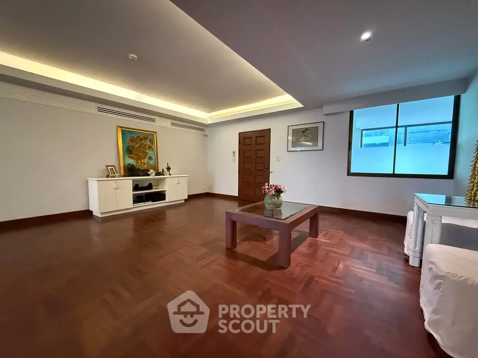 Spacious living room with elegant wooden flooring and modern decor