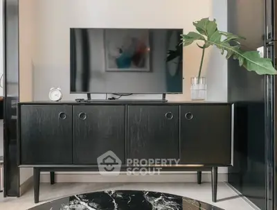 Modern living room with sleek black TV stand and stylish decor