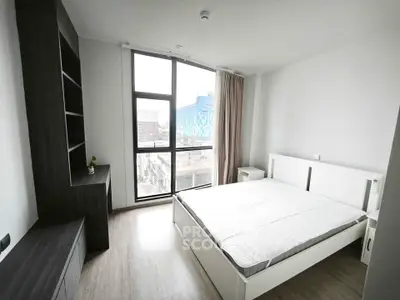 Modern bedroom with large window and minimalist decor