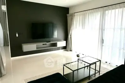 Modern living room with sleek TV setup and natural light