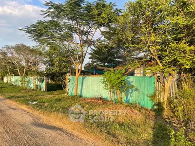 Charming rural property with lush greenery and privacy fence
