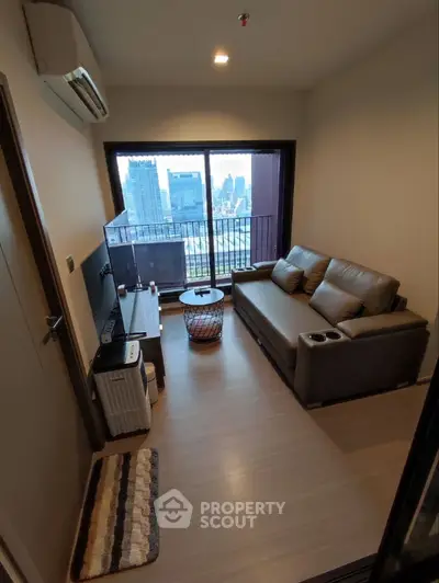 Modern living room with city view, featuring a cozy sofa and stylish decor.