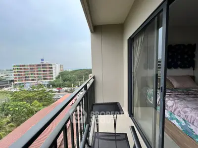 Modern balcony with city view and cozy bedroom access