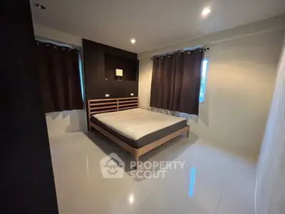 Spacious bedroom with modern design and ample natural light
