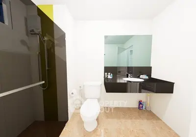 Modern bathroom with sleek fixtures and large mirror in a contemporary home.
