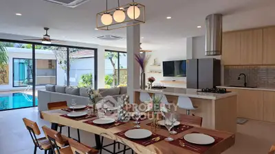Luxurious open-plan kitchen and dining area with pool view, perfect for entertaining.