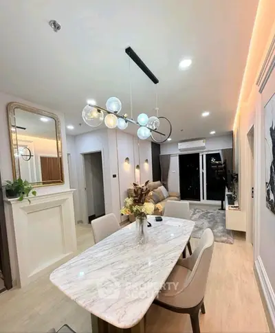 Modern living room with elegant dining area and stylish lighting in a contemporary apartment.