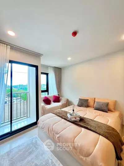 Bright and cozy bedroom with balcony view in modern apartment