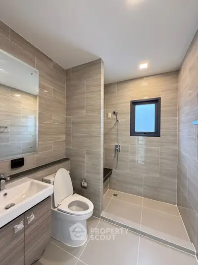 Modern bathroom with sleek tiles and walk-in shower